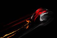 PC mouse in fast motion with flames and light trails. Single object on black background.